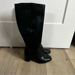Knee high heeled black boots